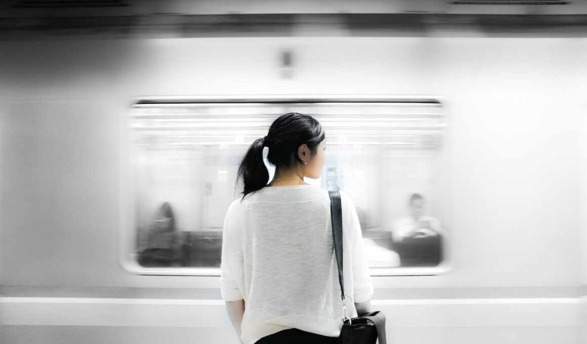 woman in white elbow-sleeved shirt standing near white train in subway