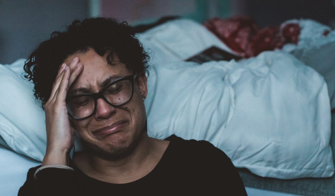 person crying beside bed